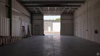 View from inside a unit out through an open roll-up door onto the drive aisle
